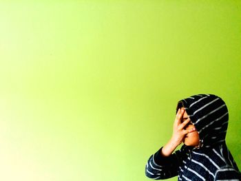 Woman holding mobile phone over white background