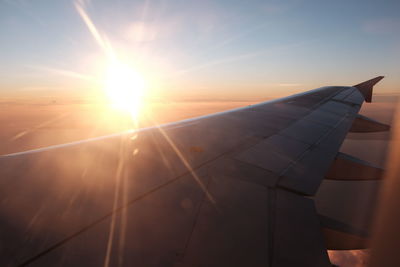 Close-up of airplane wing against sky