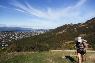 Rear view of people on mountain against sky