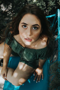 Portrait of young woman sitting on bench