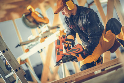 Side view of man working at construction site