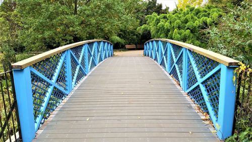 Empty  footbridge over the  pond with light blue rails in regents park london.