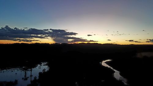 Scenic view of silhouette trees against sky during sunset