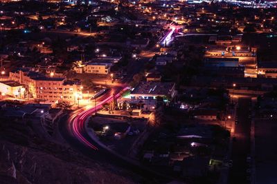 High angle view of illuminated street amidst buildings in city