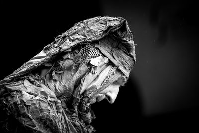 Close-up of statue against black background