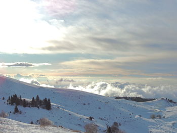 Scenic view of snow covered mountains against sky