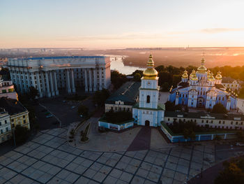 High angle view of buildings in town at sunset