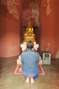 Rear view of woman in temple