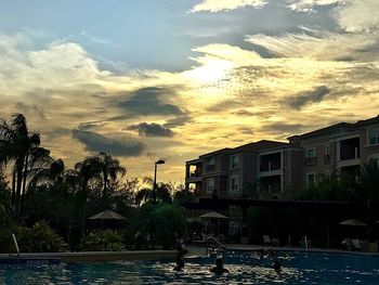 View of swimming pool at sunset