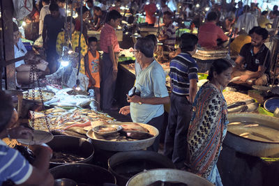 Group of people at market stall