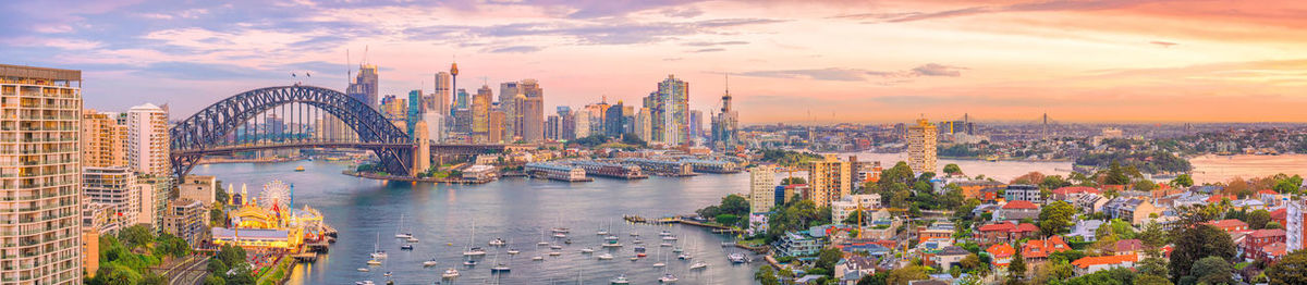 Panoramic view of bridge and buildings against sky during sunset