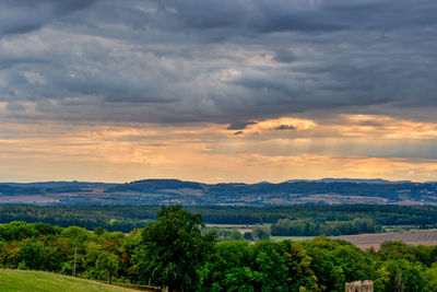 Scenic view of landscape against dramatic sky