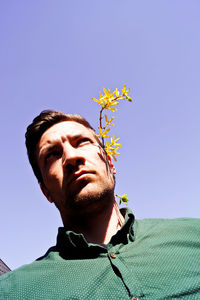 Low angle view of man against clear sky
