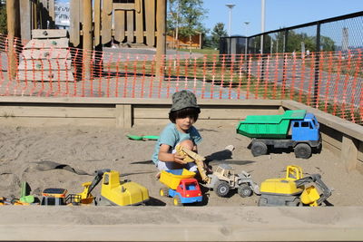 Portrait of boy playing with toy car