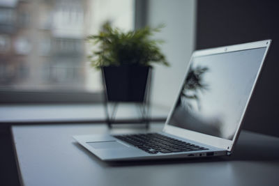 Tilt image of laptop on table at home