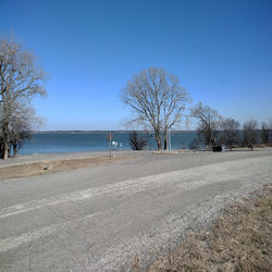 Scenic view of beach against clear blue sky