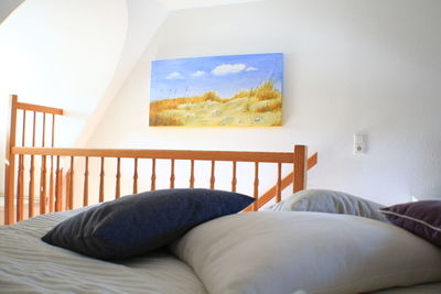 Man relaxing on bed by window at home
