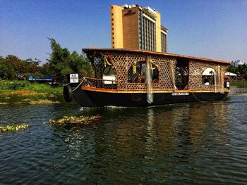 Boat moored in river against sky