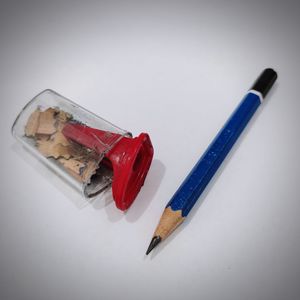 High angle view of colored pencils on table against white background