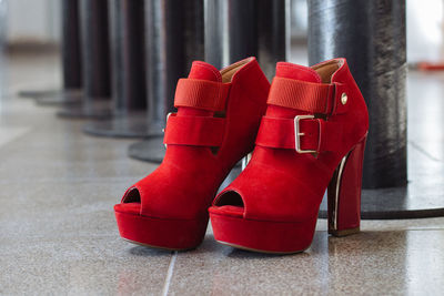 Close-up of red shoes on floor