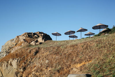 Low angle view of umbrellas against clear sky