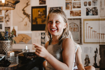 Portrait of smiling young woman using mobile phone