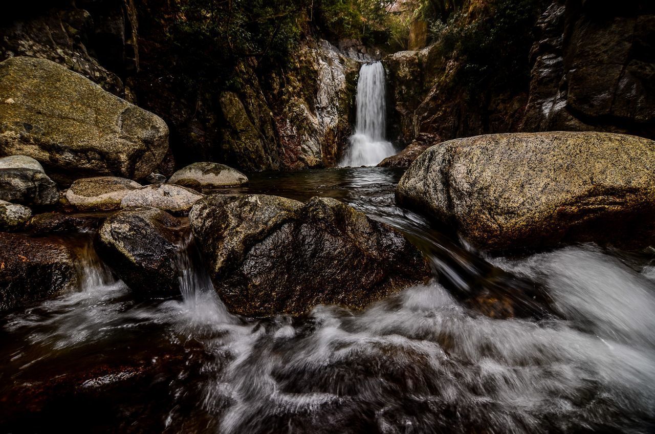 WATER FLOWING THROUGH ROCKS