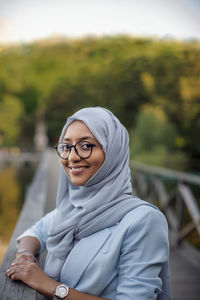 Smiling woman wearing hijab looking at camera