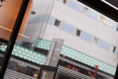 Low angle view of glass window of building