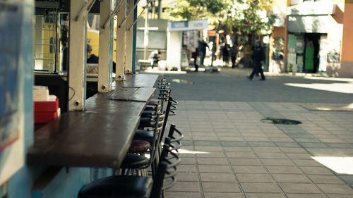 Close-up of people on sidewalk cafe in city