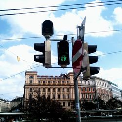 Low angle view of road sign against sky