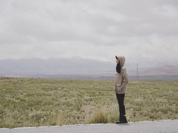 Full length of man standing on field against sky