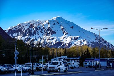 Scenic view of snowcapped mountains against blue sky