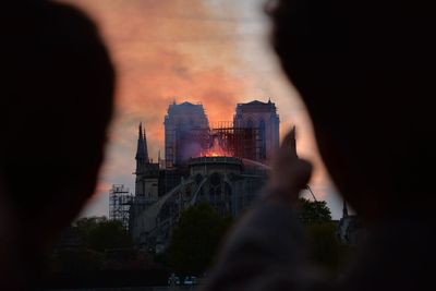 Buildings in city against sky during sunset