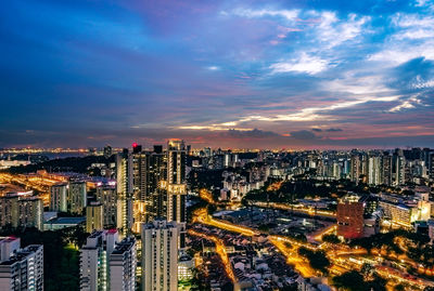 High angle view of illuminated buildings against sky during sunset