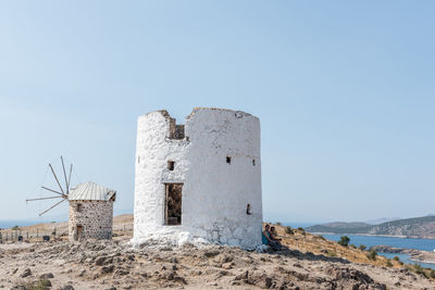 Castle by sea against clear sky