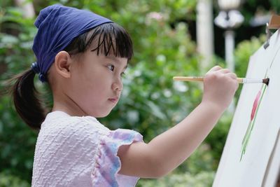 Side view portrait of cute baby holding boy