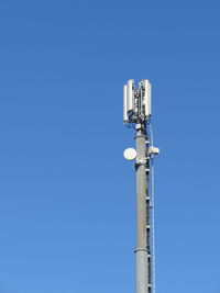 Telephone antenna on blue sky background