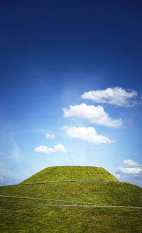 Scenic view of field against blue sky