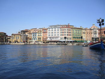 Buildings in city against clear sky