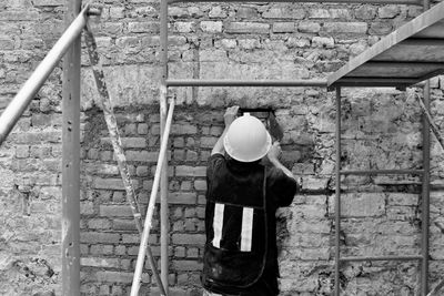 Rear view of man standing by railing