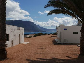 Scenic view of beach against cloudy sky