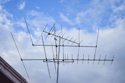 Low angle view of telephone pole against sky