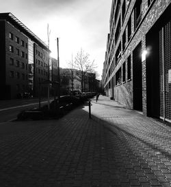 Street amidst buildings against sky in city