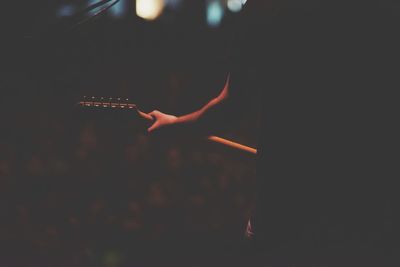 Person holding cigarette at night