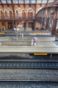 People waiting at railroad station in city