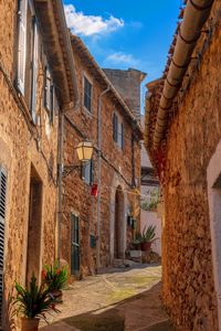 Narrow alley amidst buildings against sky