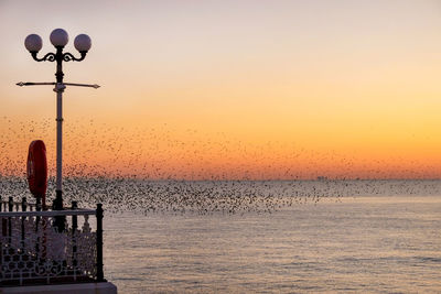 Scenic view of sea against clear sky during sunset