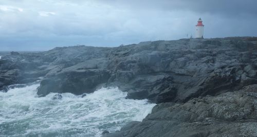 Scenic view of sea and mountain against sky