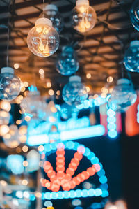 Low angle view of illuminated lanterns hanging at night